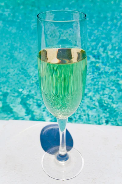 Glass of white wine on pool board outdoor — Stock Photo, Image