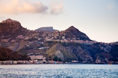 Sicilian town Taormina on sunset clipart