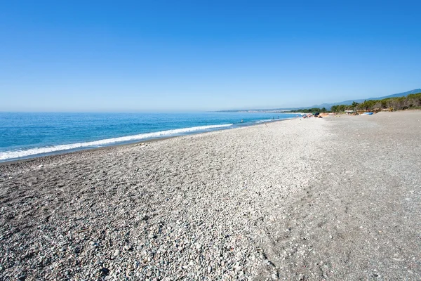 Black pebble and sand beach — Stock Photo, Image