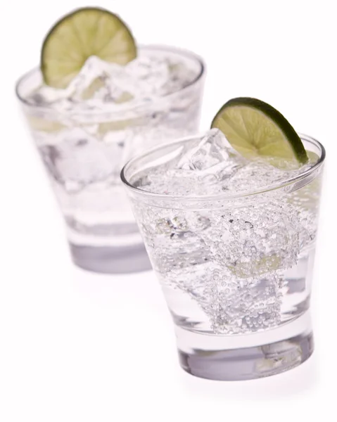 Water with ice and lime on white background — Stock Photo, Image