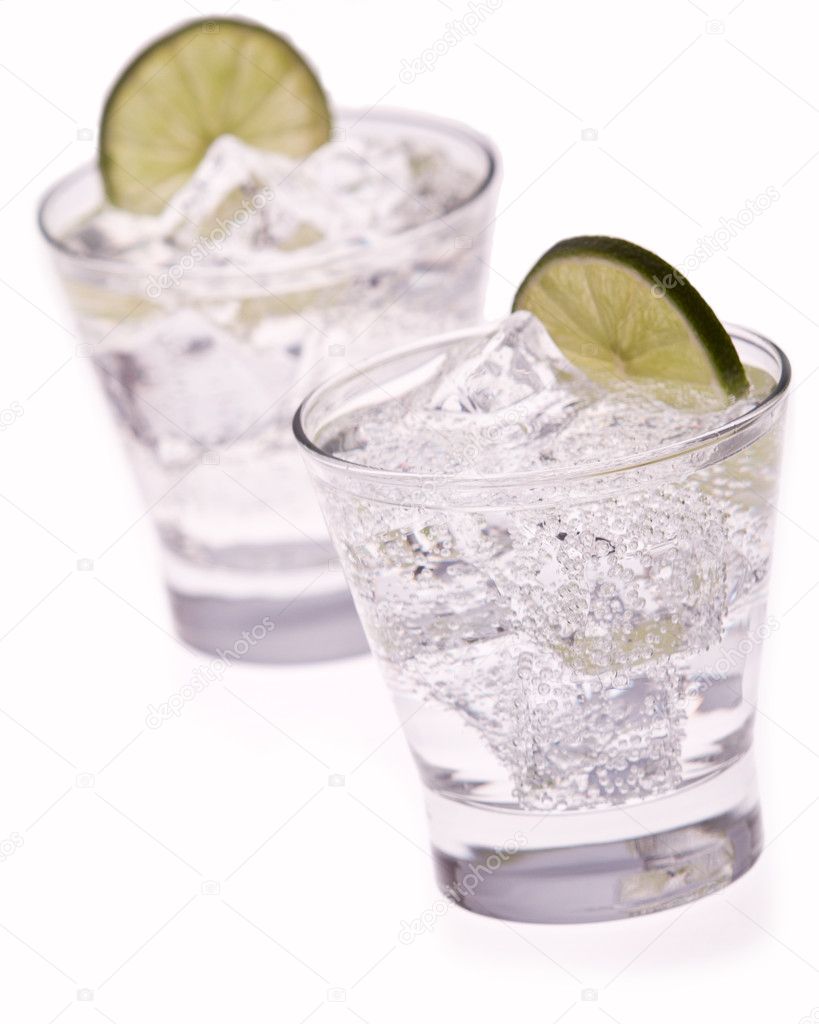 Water with ice and lime on white background