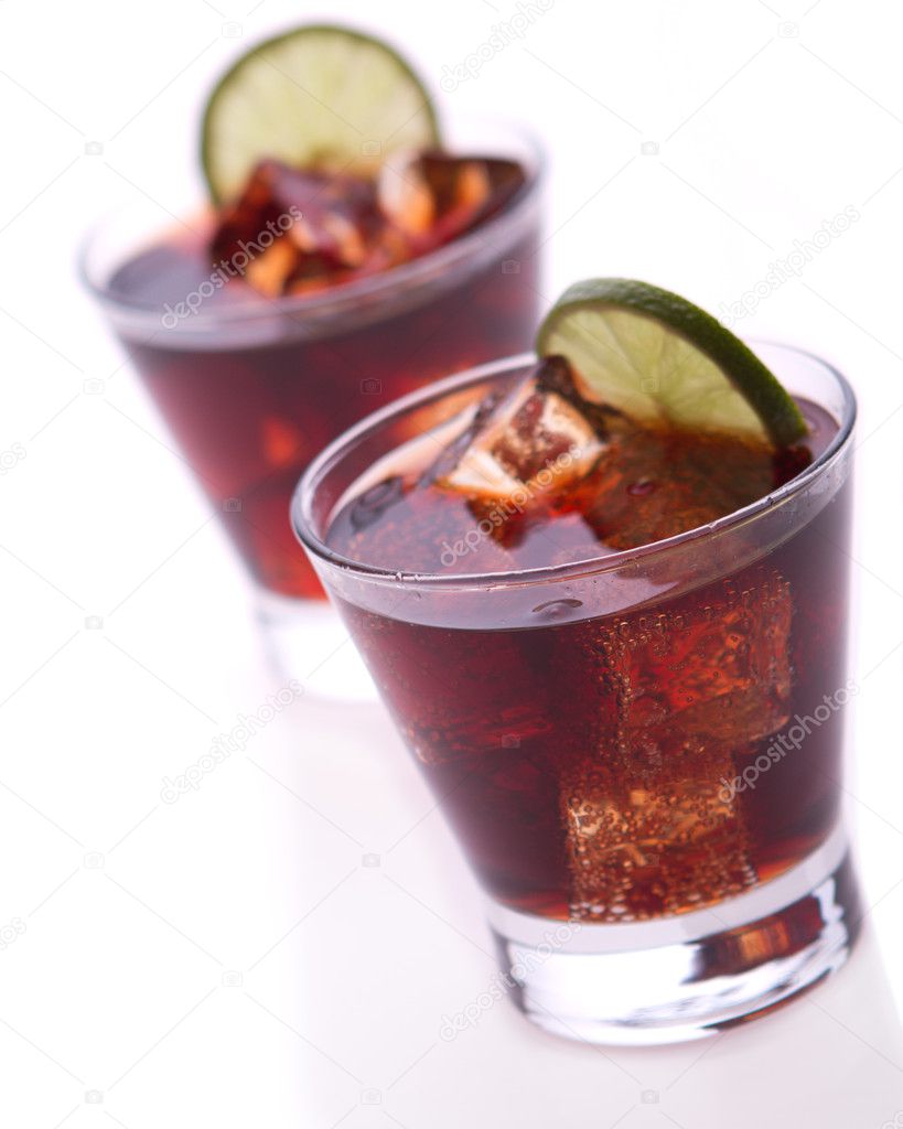 Cocktail with lime and cola on white background