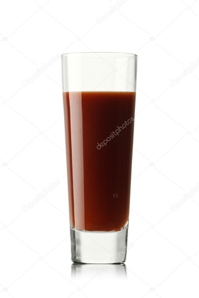 Fresh tomatoes and a glass full of tomato juice.