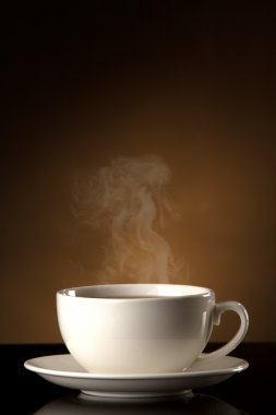 Cup of coffee with cinnamon on a old stone background. clipart