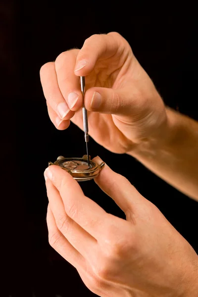 Watch-maker repairing old abraded watch — Stock Photo, Image