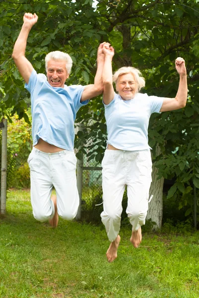 Happy couple jumping — Stock Photo, Image