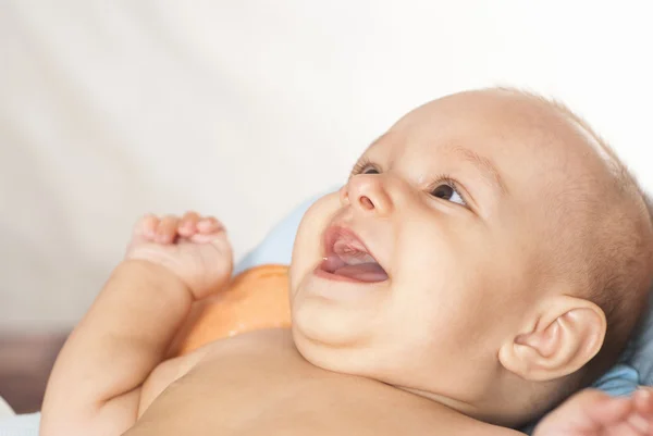 Happy newborn on a bed — Stock Photo, Image