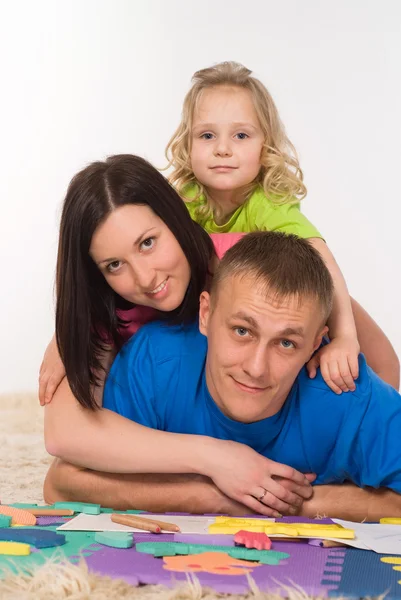 Familia en la alfombra — Foto de Stock