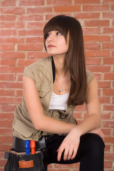 Girl against a brick wall — Stock Photo, Image