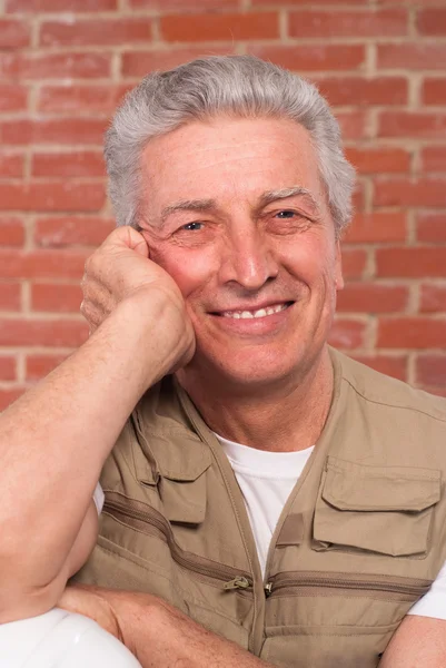 stock image Senior builder on wall background