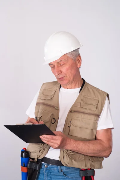 Senior bouwer schrijven — Stockfoto