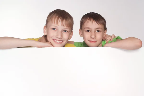 Two boys behind the board — Stock Photo, Image