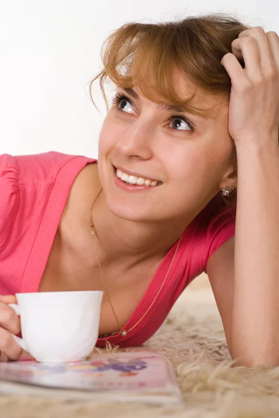 Pretty girl lying with cup — Stock Photo, Image