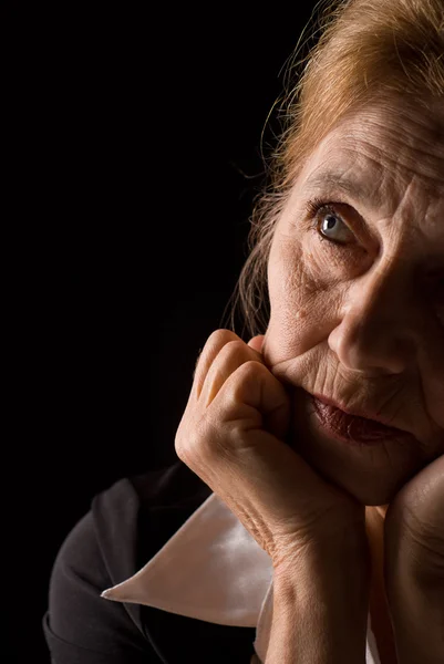 stock image Old woman on black