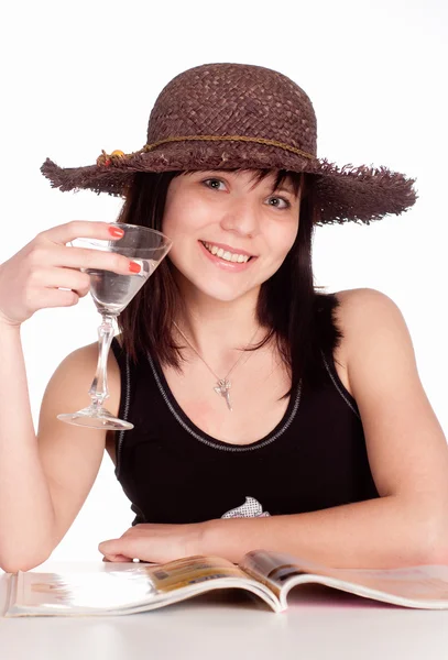 Girl in hat drinks — Stock Photo, Image