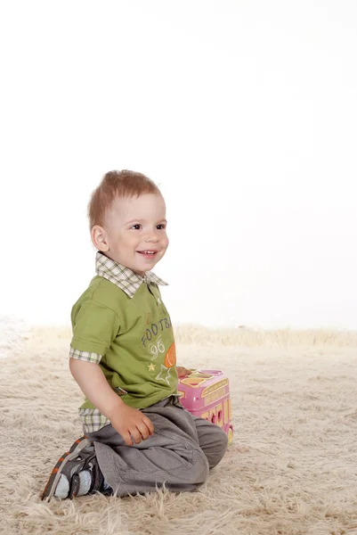 Pretty boy on carpet — Stock Photo, Image