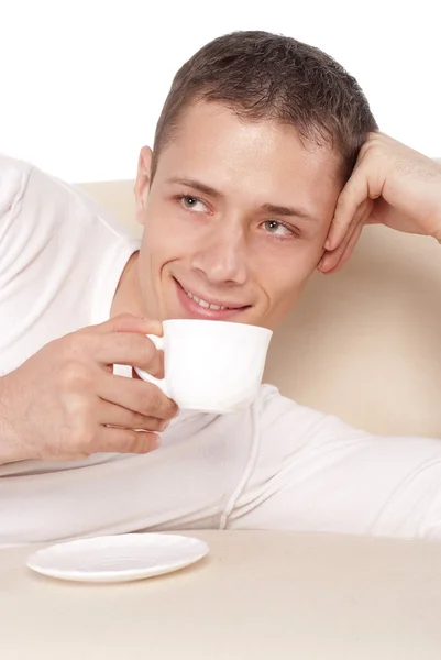 Guy with cup on sofa — Stock Photo, Image