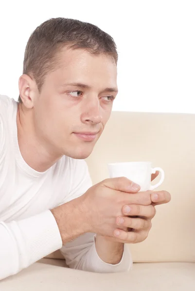 Guy with cup on sofa — Stock Photo, Image