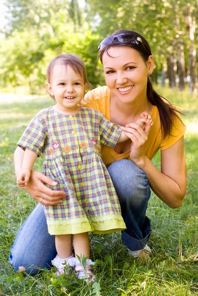 Mom and child on a grass — Stock Photo, Image
