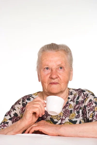 Бабушка за столом — стоковое фото