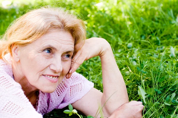 Old woman lying Royalty Free Stock Photos