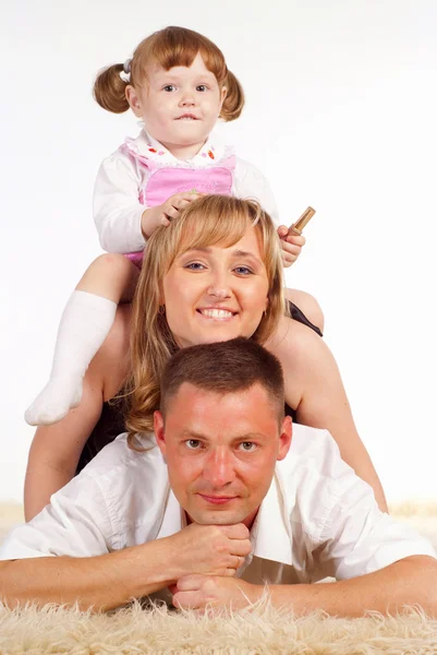 カーペットの上にかわいい家族 — ストック写真