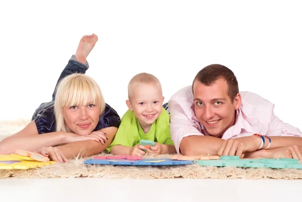 Familia en una alfombra —  Fotos de Stock