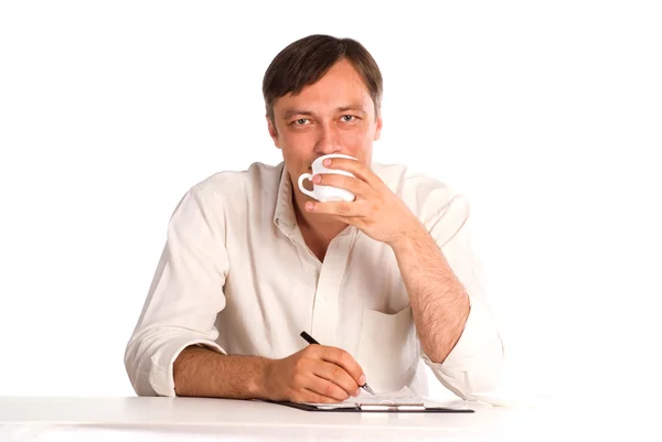 Man at table with cup — Stock Photo, Image