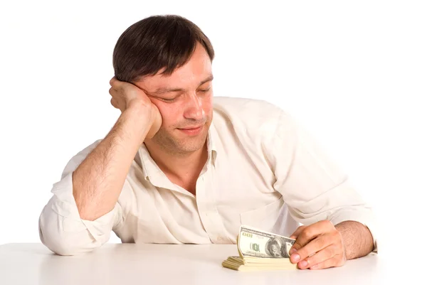 Man at table with cash — Stock Photo, Image