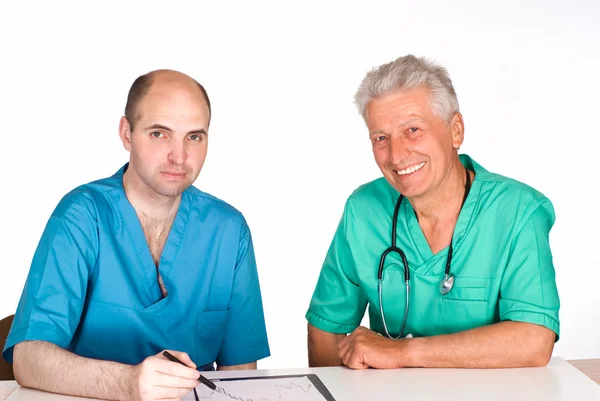 Två läkare vid bord — Stockfoto