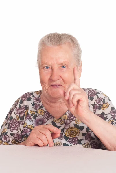 Oma an einem Tisch — Stockfoto