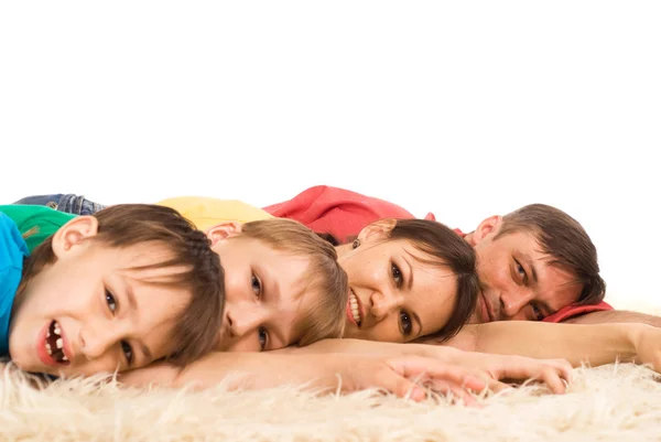 Cute family lying on carpet — Stock Photo, Image