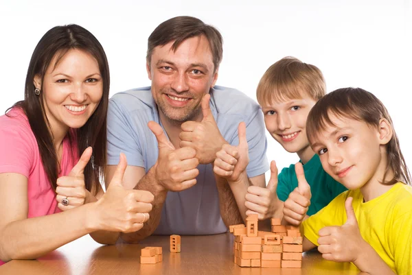 Happy family playing at table — Stock Photo, Image