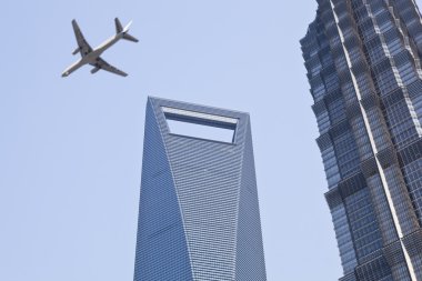 Shanghai: plane over modern buildings clipart