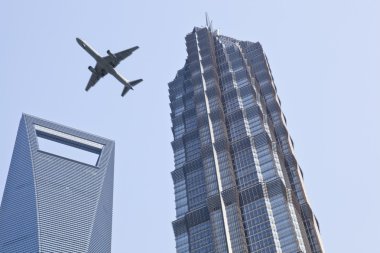 Shanghai: plane over modern buildings clipart
