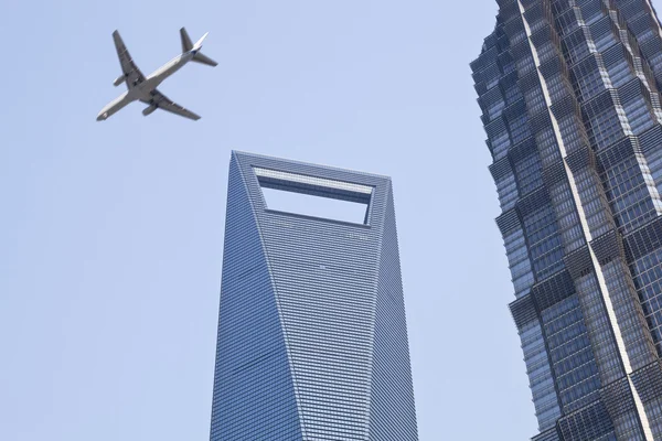 Shanghai: plane over modern buildings — Stock Photo, Image