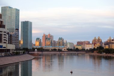 Ishim river in Astana at dusk clipart