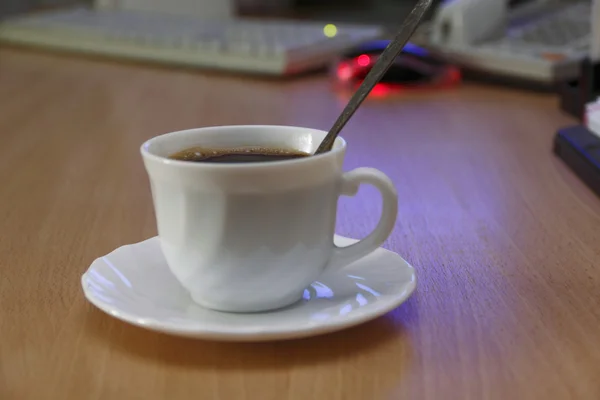 Cup of coffee in office — Stock Photo, Image