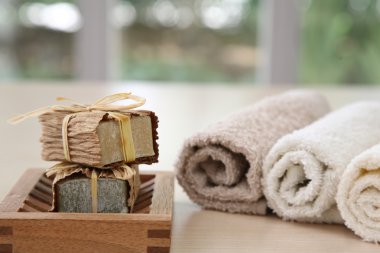 Nice soaps with towels in natural colours clipart