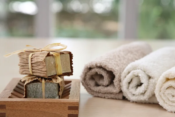 Nice soaps with towels in natural colours — Stock Photo, Image