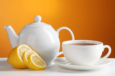 Cup of tea with teapot and lemon clipart