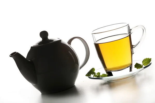 Xícara de chá com bule preto — Fotografia de Stock