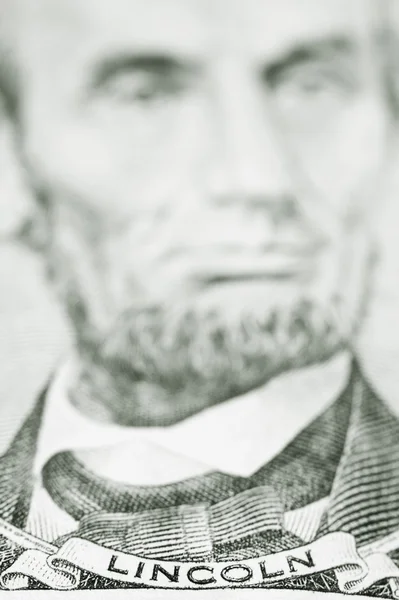 Close up of President Lincoln on five dollar bill — ストック写真
