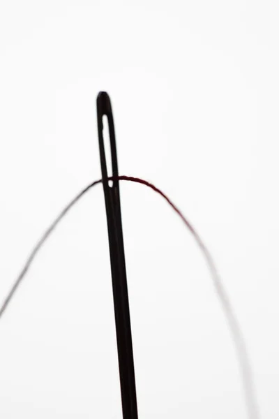 Einfädeln einer Nadel in Silhouette — Stockfoto