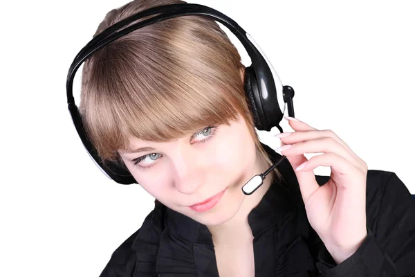 Het mooie meisje in oor-telefoons met een microfoon Stockfoto