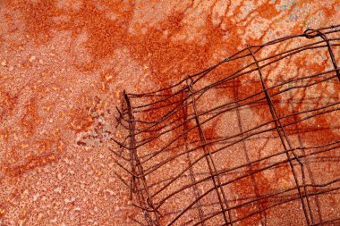 Horzontal format of red rusty wire on rusted metal plate clipart