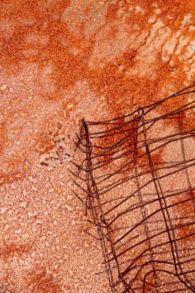 Wire and shadow on red rusty metal plate — Stock Photo, Image