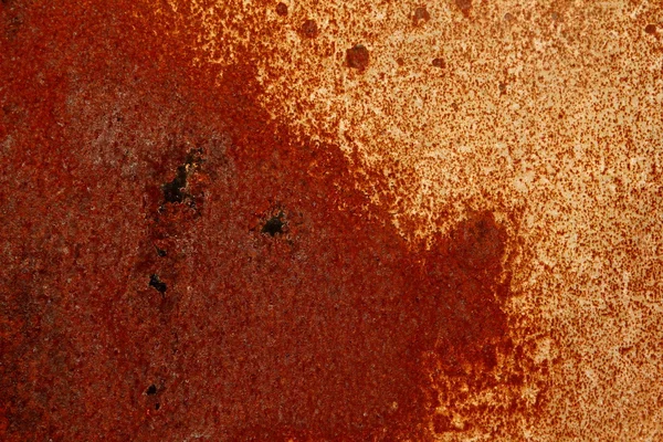 Mottled red rust and shapes on a sheet of metal — Stock Photo, Image