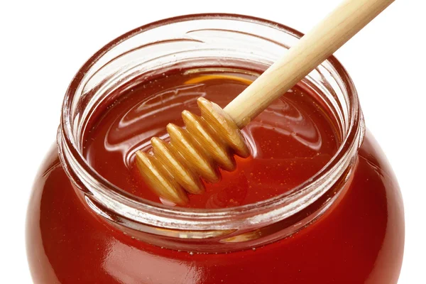 Trä skopa med burk honung. — Stockfoto