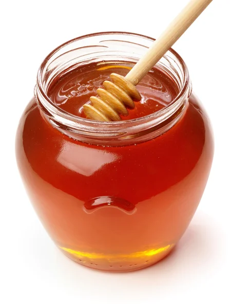 Trä skopa med burk honung. — Stockfoto